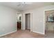 Comfortable bedroom with ceiling fan leads to bathroom and other rooms for easy access at 14266 Creek Run Dr, Riverview, FL 33579