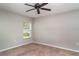 Inviting bedroom features ceiling fan and window providing natural light and carpeted floor at 14266 Creek Run Dr, Riverview, FL 33579