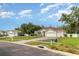 Single-story home with manicured lawn, long driveway, and attached two-car garage under blue sky at 14266 Creek Run Dr, Riverview, FL 33579