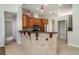 Open kitchen with stainless steel appliances, wood cabinets, and a granite breakfast bar at 14266 Creek Run Dr, Riverview, FL 33579