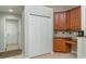 Kitchenette with desk, granite countertop, and wooden cabinets at 14266 Creek Run Dr, Riverview, FL 33579
