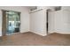 Spacious living room featuring carpet floors, sliding glass doors, and neutral walls at 14266 Creek Run Dr, Riverview, FL 33579