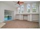 Bright living room featuring a ceiling fan, large windows, neutral paint, and sliding door to patio at 14266 Creek Run Dr, Riverview, FL 33579