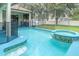 Enclosed pool area features a built-in hot tub, safety fence, and an abundance of room to relax at 14266 Creek Run Dr, Riverview, FL 33579