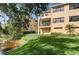 Backyard view with lawn, pond access, and partial view of townhome at 1531 Ember Ln, Tarpon Springs, FL 34689
