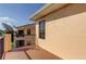 Balcony overlooking lush landscaping, with peach stucco wall and black railing at 1531 Ember Ln, Tarpon Springs, FL 34689