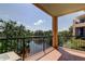 A covered balcony with a scenic view of a lake and trees at 1531 Ember Ln, Tarpon Springs, FL 34689