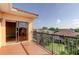 Balcony with tiled floor and black railings, overlooking a grassy neighborhood at 1531 Ember Ln, Tarpon Springs, FL 34689