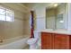 Well-lit bathroom featuring a tub with shower, a window and a vanity sink with cabinet at 1531 Ember Ln, Tarpon Springs, FL 34689