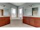 Bright bathroom featuring a soaking tub, double vanity, and tile flooring at 1531 Ember Ln, Tarpon Springs, FL 34689