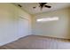 Bedroom with closet, ceiling fan, window and neutral carpet at 1531 Ember Ln, Tarpon Springs, FL 34689