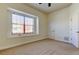 Spacious bedroom with large window, white trim and doors, and neutral carpet at 1531 Ember Ln, Tarpon Springs, FL 34689