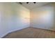 Neutral bedroom with small built-in desk, neutral carpet and trim, and white walls at 1531 Ember Ln, Tarpon Springs, FL 34689