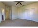 Spacious carpeted bedroom featuring a ceiling fan and double door closet for ample storage at 1531 Ember Ln, Tarpon Springs, FL 34689