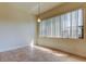 Bright dining room featuring tile floors and a large window letting in natural light at 1531 Ember Ln, Tarpon Springs, FL 34689