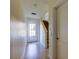 Neutral-toned entryway featuring tile flooring, a staircase, glass-paned door, and access to other rooms at 1531 Ember Ln, Tarpon Springs, FL 34689