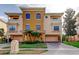Attractive three-story home featuring balconies, manicured lawn, and a two-car garage at 1531 Ember Ln, Tarpon Springs, FL 34689