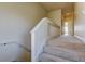 Carpeted stairs leading to the hallway with neutral walls and white railings at 1531 Ember Ln, Tarpon Springs, FL 34689