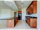 Spacious kitchen featuring custom cabinets, granite counters and an island with a breakfast bar at 1531 Ember Ln, Tarpon Springs, FL 34689