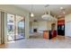 Open kitchen with a breakfast bar, adjacent to a living room with a fireplace and sliding glass doors at 1531 Ember Ln, Tarpon Springs, FL 34689