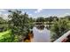 Picturesque lake view framed by lush trees, offering a tranquil and natural setting at 1531 Ember Ln, Tarpon Springs, FL 34689
