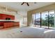 Spacious living room featuring a sliding door to a balcony and open to a kitchen with wooden cabinets at 1531 Ember Ln, Tarpon Springs, FL 34689