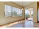 Living Room showcasing tile flooring, large windows and sliding glass doors to balcony at 1531 Ember Ln, Tarpon Springs, FL 34689