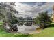 Picturesque pond surrounded by lush trees and greenery, creating a serene and natural landscape at 1531 Ember Ln, Tarpon Springs, FL 34689