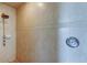 Walk-in shower featuring neutral tile with decorative border and brass fixtures at 1531 Ember Ln, Tarpon Springs, FL 34689