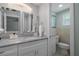 Bright bathroom featuring a vanity with stone countertop and a tiled shower stall at 15713 Century Dr, Hudson, FL 34667