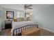 This light-filled bedroom features a ceiling fan, and dual mirrored wardrobes at 15713 Century Dr, Hudson, FL 34667