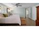 Relax in this cozy bedroom featuring a ceiling fan and easy access to a full bath at 15713 Century Dr, Hudson, FL 34667