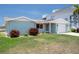 Charming single-story home featuring a well-kept lawn, attached garage and mature landscaping at 15713 Century Dr, Hudson, FL 34667
