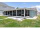A screened-in porch on a green lawn with a light-blue exterior at 15713 Century Dr, Hudson, FL 34667