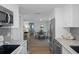 Open kitchen layout with modern appliances and view into the dining area at 15713 Century Dr, Hudson, FL 34667