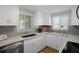Bright kitchen featuring white cabinets, granite countertops, and stainless steel appliances at 15713 Century Dr, Hudson, FL 34667