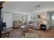 Comfortable living area with plush couches, wood flooring, and a bright, inviting atmosphere at 15713 Century Dr, Hudson, FL 34667