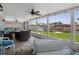 Inviting screened porch with comfortable seating, ceiling fans, and views of the canal at 15713 Century Dr, Hudson, FL 34667