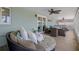 A screened porch features a stylish seating area, ceiling fans, and seamless indoor-outdoor flow at 15713 Century Dr, Hudson, FL 34667