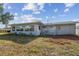 The back exterior shows the home's utility connections and manicured garden bed at 1701 62Nd S Ter, St Petersburg, FL 33712