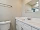 Bathroom vanity features white cabinets and a sink with marble-look countertop at 1701 62Nd S Ter, St Petersburg, FL 33712