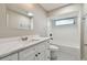 Renovated bathroom with gray tile floors, a white vanity with modern fixtures, and a tub with white subway tile at 1701 62Nd S Ter, St Petersburg, FL 33712