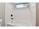 Bathroom tub featuring white subway tile and a mounted shower head at 1701 62Nd S Ter, St Petersburg, FL 33712