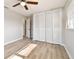 Bedroom with wood-look floors, bi-fold closet and neutral paint at 1701 62Nd S Ter, St Petersburg, FL 33712