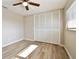 A bedroom featuring light-colored walls, wood-look floors, closet and a window for natural light at 1701 62Nd S Ter, St Petersburg, FL 33712