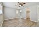 Bedroom featuring wood-look flooring, closet, and view into en suite bathroom at 1701 62Nd S Ter, St Petersburg, FL 33712