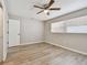 Cozy bedroom with wood-look flooring, window, and ceiling fan with lighting at 1701 62Nd S Ter, St Petersburg, FL 33712