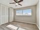 Bright bedroom with wood-look flooring, a ceiling fan and a large window for natural light at 1701 62Nd S Ter, St Petersburg, FL 33712