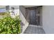 Close-up view of the front door, showcasing stylish tile flooring and well-maintained greenery at 1701 62Nd S Ter, St Petersburg, FL 33712