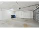 Spacious garage featuring a clean concrete floor, overhead lighting, and a functional door at 1701 62Nd S Ter, St Petersburg, FL 33712